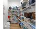 Walk-in pantry with ample shelving for food storage at 3070 Smilodon Trl, Ruskin, FL 33570