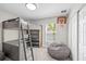 Bedroom featuring bunk bed, window, gray carpet, bean bag, and basketball hoop at 3110 W Ballast Point Blvd, Tampa, FL 33611