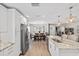 Bright, open kitchen with stainless steel appliances, granite countertops, and adjacent dining area at 3110 W Ballast Point Blvd, Tampa, FL 33611
