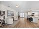 Open living room featuring hardwood floors, white accents, and white kitchen in the background at 3110 W Ballast Point Blvd, Tampa, FL 33611