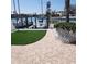 Waterfront property featuring a boat dock with lush landscaping and boat mooring at 319 Boca Ciega Dr, Madeira Beach, FL 33708