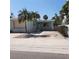 Charming coastal home with a light blue facade, palm trees and white picket fence at 319 Boca Ciega Dr, Madeira Beach, FL 33708