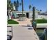 Front yard with green grass, mature trees and waterway at 319 Boca Ciega Dr, Madeira Beach, FL 33708