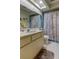 This bathroom features a single sink, toilet and shower/tub combo with tile flooring at 3283 Hilary Cir # 2C, Palm Harbor, FL 34684