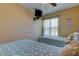 This bedroom features two twin beds with a ceiling fan and a mounted TV at 3283 Hilary Cir # 2C, Palm Harbor, FL 34684