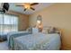 Bright bedroom featuring two twin beds with matching floral pattern and a decorative mirror at 3283 Hilary Cir # 2C, Palm Harbor, FL 34684