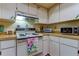 Cozy kitchen with essential appliances, ample cabinet storage and countertop space, ready for your culinary adventures at 3283 Hilary Cir # 2C, Palm Harbor, FL 34684