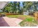 Spacious backyard with brick patio, grassy area, and a fenced perimeter, perfect for outdoor enjoyment at 3317 W Iowa Ave, Tampa, FL 33611