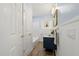 Charming bathroom with blue accents, vessel sink, updated fixtures, and wainscoting for added elegance at 3317 W Iowa Ave, Tampa, FL 33611