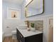 Updated bathroom showcasing a vessel sink, tiled backsplash, and modern gold fixtures for a stylish touch at 3317 W Iowa Ave, Tampa, FL 33611