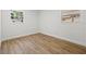 Bright bedroom featuring wood-look floors, neutral walls, and two windows offering ample natural light at 3317 W Iowa Ave, Tampa, FL 33611