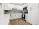 Modern kitchen with white cabinets, stainless steel appliances, quartz countertops, and stylish backsplash at 3317 W Iowa Ave, Tampa, FL 33611
