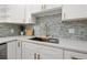 This kitchen features a stylish sink with modern faucet and colorful backsplash at 3317 W Iowa Ave, Tampa, FL 33611