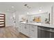 Open-concept kitchen with island, quartz countertops, stainless steel appliances, and hardwood floors at 3317 W Iowa Ave, Tampa, FL 33611