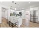 Bright open kitchen featuring modern stainless steel appliances, island with seating, and updated cabinets at 3317 W Iowa Ave, Tampa, FL 33611