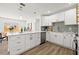 Bright kitchen featuring white cabinets, quartz countertops, stainless steel appliances and breakfast bar seating at 3317 W Iowa Ave, Tampa, FL 33611