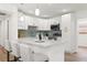 Bright kitchen featuring white cabinets, modern appliances, and a breakfast bar area at 3317 W Iowa Ave, Tampa, FL 33611