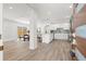 Open-concept kitchen flows into dining area, featuring hardwood floors, white cabinetry and stainless appliances at 3317 W Iowa Ave, Tampa, FL 33611