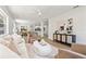 Open living room features modern furnishings, light color palette, and wood-look flooring at 3317 W Iowa Ave, Tampa, FL 33611