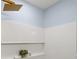 Contemporary shower featuring white tile, contrasting blue walls, and gold shower head creating a serene space at 3317 W Iowa Ave, Tampa, FL 33611