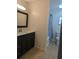 Bathroom featuring dark cabinets, tiled floors, and a shower/tub combo with white fixtures at 3403 Jamais Wood Way, Tampa, FL 33618