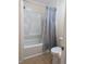 Bright bathroom featuring a shower-tub combination with tiled floors and neutral wall colors at 3403 Jamais Wood Way, Tampa, FL 33618