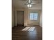 Sunlit bedroom showcasing wood flooring, ceiling fan, window, and a closet at 3403 Jamais Wood Way, Tampa, FL 33618