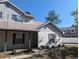 Home exterior showcasing the porch, white brick, well maintained landscaping and a pristine walkway at 3403 Jamais Wood Way, Tampa, FL 33618