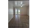 Living room showcasing tiled flooring, a ceiling fan, and sliding glass doors leading to the backyard at 3403 Jamais Wood Way, Tampa, FL 33618