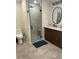 Modern bathroom featuring a double sink vanity, glass enclosed shower and hexagon patterned floor at 3505 Gloria Ave, Plant City, FL 33563