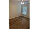 This bedroom features wood flooring and natural light from the window at 3505 Gloria Ave, Plant City, FL 33563
