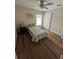 This bedroom features wood flooring and a window at 3505 Gloria Ave, Plant City, FL 33563