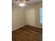 This bedroom features wood flooring and natural light from the window at 3505 Gloria Ave, Plant City, FL 33563