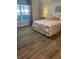 Cozy bedroom features laminate floors, stylish quilt and a large window for natural light at 3505 Gloria Ave, Plant City, FL 33563