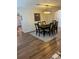 This dining room features hardwood floors, six chairs, and modern lighting at 3505 Gloria Ave, Plant City, FL 33563