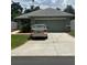 Charming one-story home with a gray roof, lush lawn and a spacious two-car garage at 3505 Gloria Ave, Plant City, FL 33563