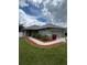 Well-maintained front yard showcasing the exterior of the house with a two car garage at 3505 Gloria Ave, Plant City, FL 33563
