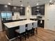 Contemporary kitchen with an island, dark cabinets, stainless steel appliances, and a geometric tile backsplash at 3505 Gloria Ave, Plant City, FL 33563