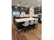 Modern kitchen with an island, stainless steel appliances, stylish pendant lighting, and dark cabinetry at 3505 Gloria Ave, Plant City, FL 33563