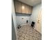 The laundry room features patterned flooring and extra cabinet storage at 3505 Gloria Ave, Plant City, FL 33563