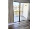 Balcony area with wood laminate flooring and a waterfront view of the adjacent building at 3840 N Lake Dr # 125, Tampa, FL 33614