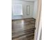 Bedroom with a neutral color palette, featuring wood laminate flooring and blinds at 3840 N Lake Dr # 125, Tampa, FL 33614