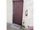 Entry door to unit 125 is burgundy with a gray mat and a fire extinguisher at 3840 N Lake Dr # 125, Tampa, FL 33614