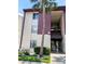 Exterior of a two story apartment featuring a palm tree and manicured bushes in front of the property at 3840 N Lake Dr # 125, Tampa, FL 33614