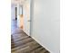 Hallway leading to a kitchen featuring durable wood-look floors, and white walls creating a clean and open space at 3840 N Lake Dr # 125, Tampa, FL 33614