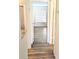 Hallway leading to a room with wood laminate flooring and a large window with blinds at 3840 N Lake Dr # 125, Tampa, FL 33614