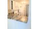 Bright kitchen featuring white cabinets, white appliances, and a marble countertop at 3840 N Lake Dr # 125, Tampa, FL 33614