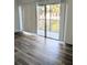 Living room features wood laminate flooring and sliding glass doors opening to a patio at 3840 N Lake Dr # 125, Tampa, FL 33614