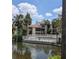 Community pool with lush landscaping, mature trees, and calm lake views at 3840 N Lake Dr # 125, Tampa, FL 33614