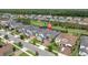 Aerial view of a residential neighborhood featuring sidewalks, green spaces and mature trees at 3850 Bonfire Dr, Odessa, FL 33556